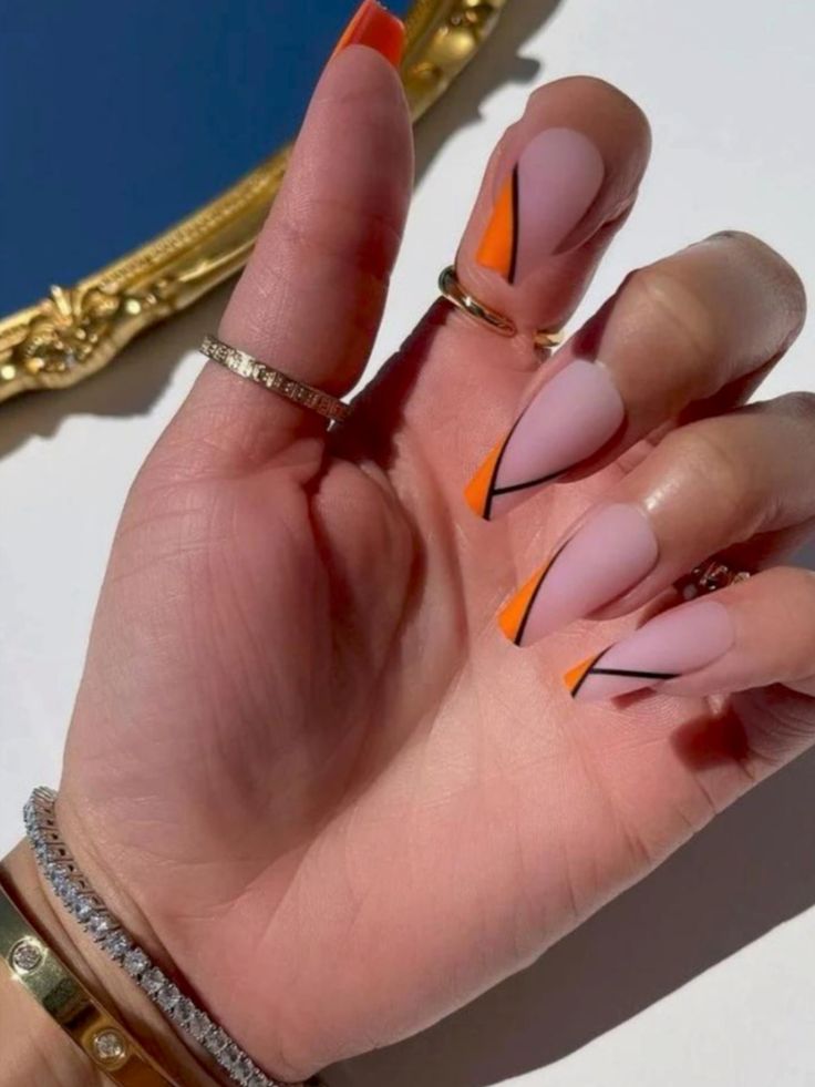 Contemporary Matte Pink and Orange Tip Nails with Geometric Black Accents.