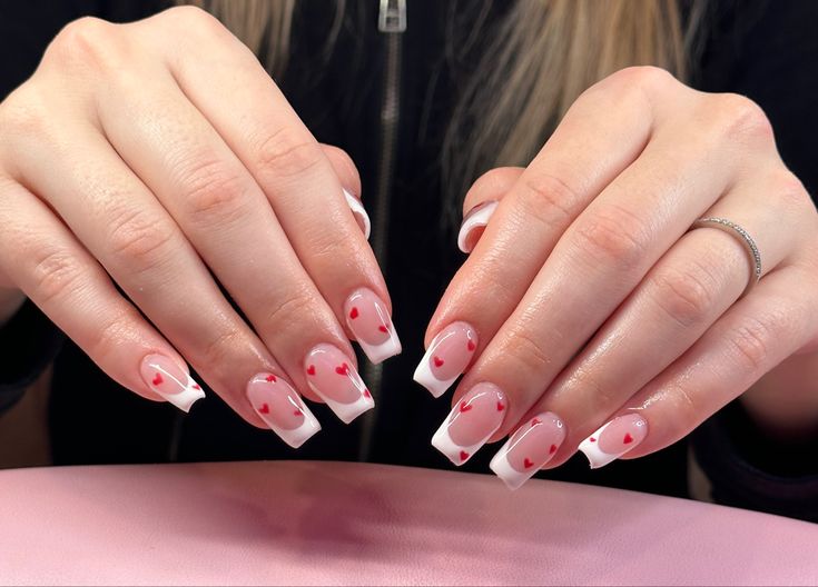 Charming Romantic Nail Design with Soft Pink, White, and Red Heart Accents.