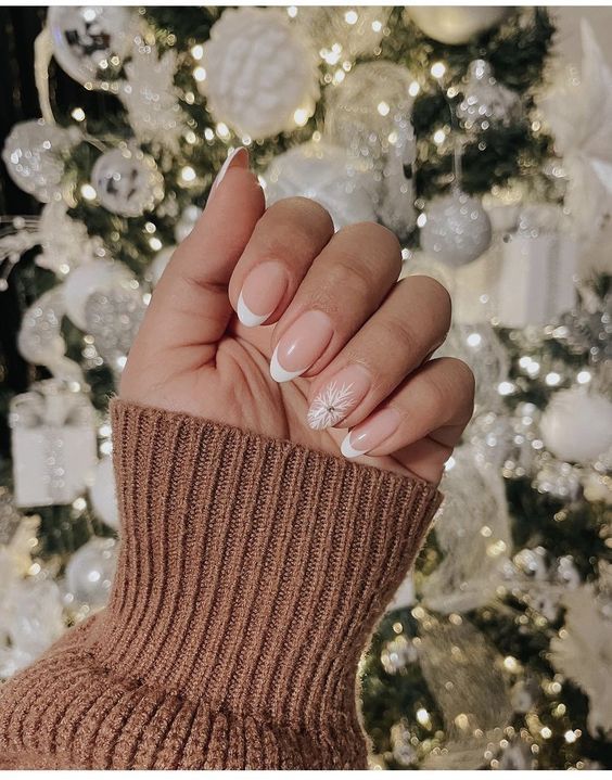 Chic Holiday Nail Design: Classic French Tips with Festive Snowflake Accents.