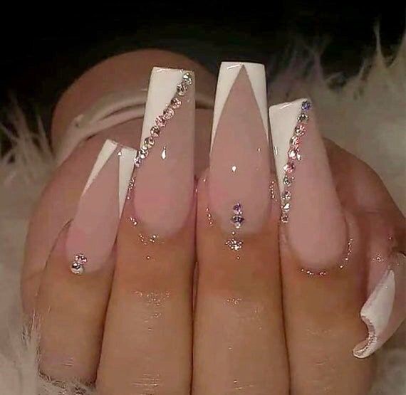 Sophisticated Long Tapered Nail Design with Light Pink and Crisp White Accents and Rhinestones.