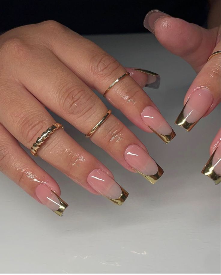 Sophisticated Nude Nail Design with Gold Metallic Edges and Minimalistic Accessories.