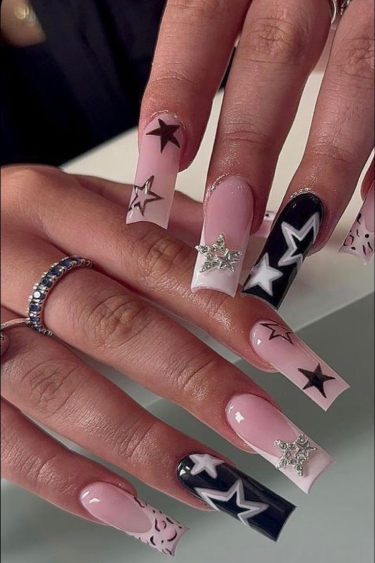 Chic Nail Design: Pastel Pink, Bold Black, and Crisp White with Trendy Star Embellishments