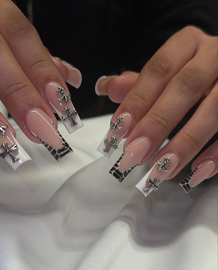 Elegant Long Nails with Nude and White Tips, Intricate Silver Charms, and Chic Snake Print.