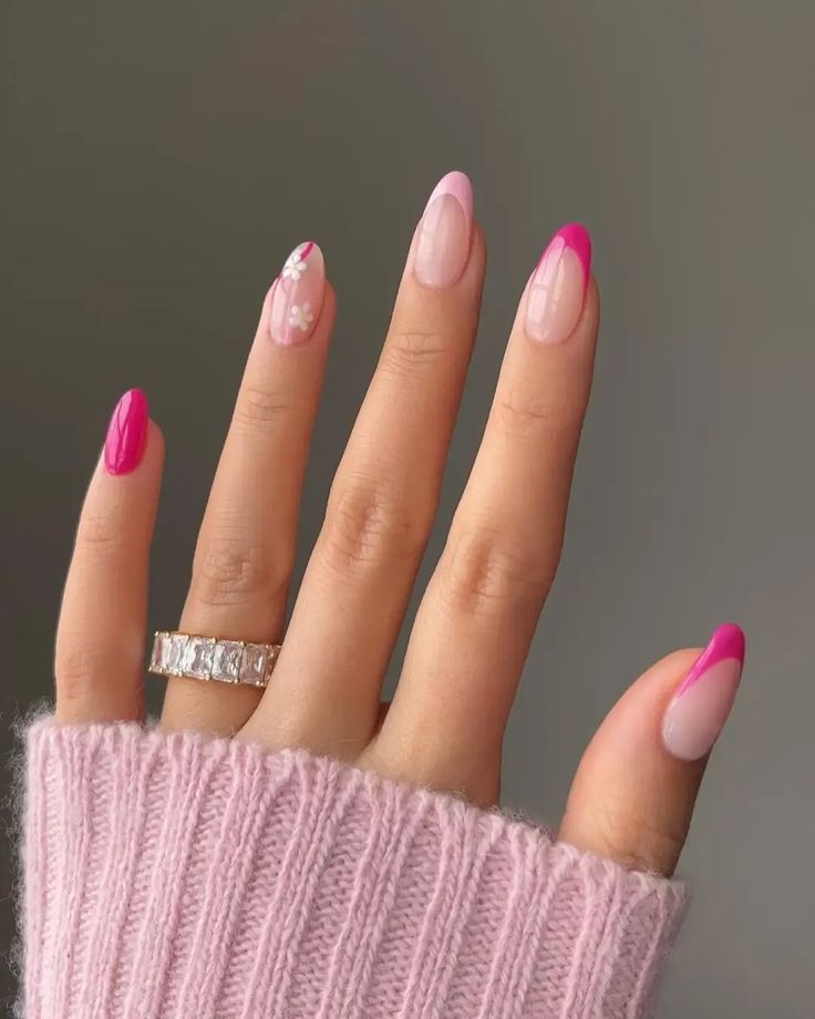 Playful Chic: Elegant Almond-Shaped Nails with Gradient Pink and Fuchsia Tips and Floral Accents.