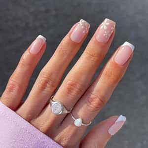 Elegant Soft Pink and White French Tips with Floral Accents for a Feminine Manicure.