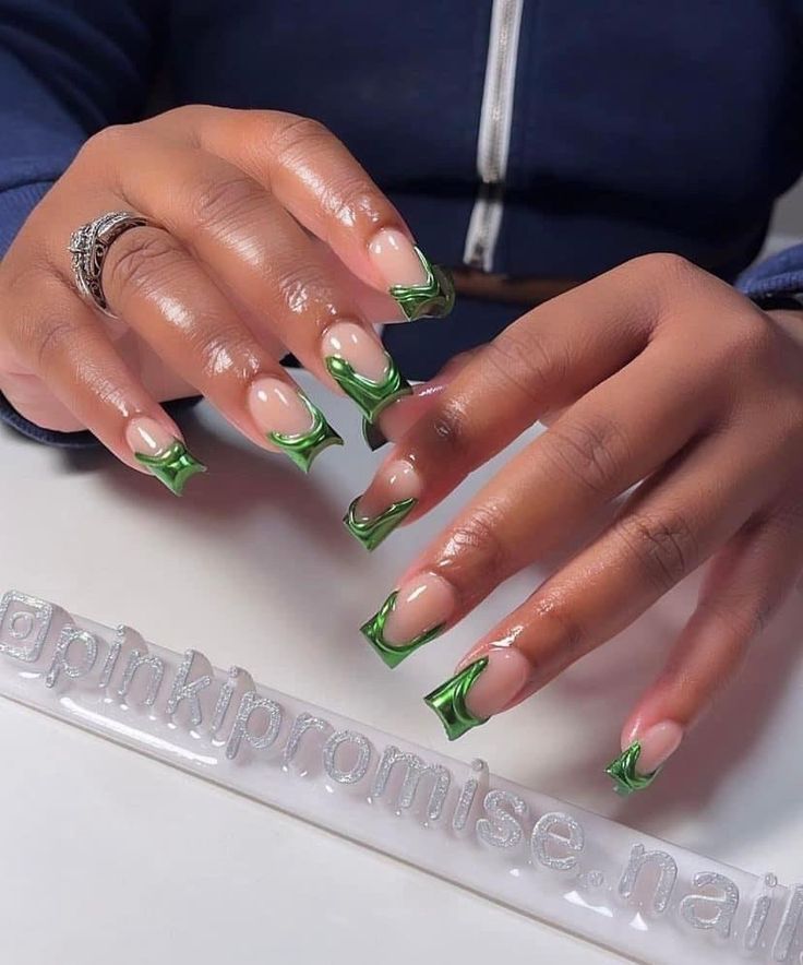 Chic and Playful Nail Design: Neutral Base with Striking Green Tips and Creative Swirls.