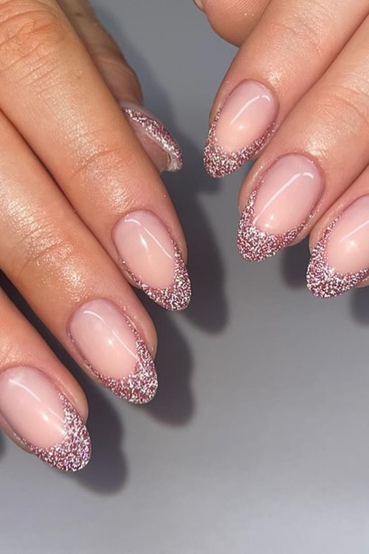 Elegant French Tip Nail Design: Subtle Nude Base with Sparkling Pink Glitter Tips