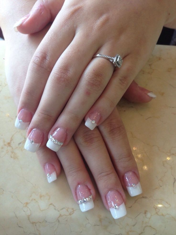 Sophisticated French Manicure: Classic White Tips and Subtle Pink Base with Rhinestone Accents.