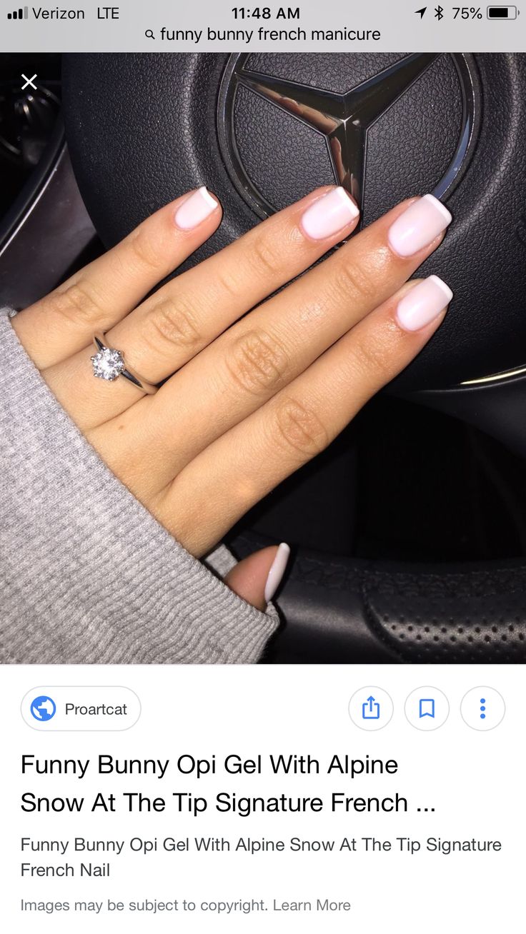 Chic Elegant French Manicure with Soft Pink and White Shades and Glamorous Ring Accent.