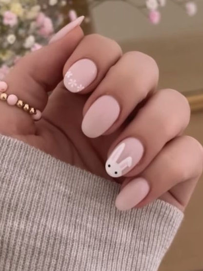 Whimsical Spring Nail Design: Soft Pink with Bunny Illustration and Floral Accents