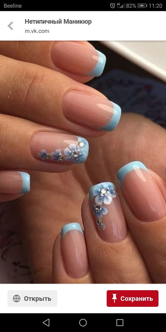 Charming Pastel Blue French Manicure with Floral Accents.