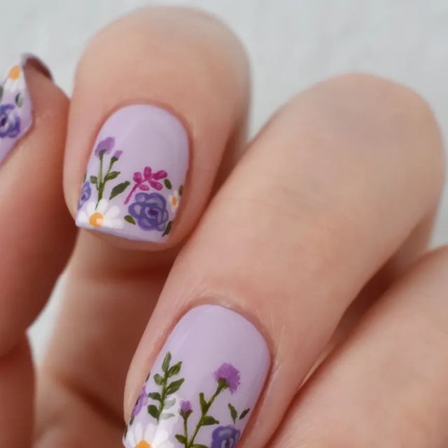 Elegant Floral Nail Design in Delicate Purple Shades with Artistic Details