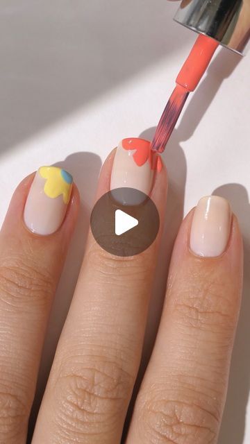 Playful Floral Nail Design on Soft Nude Base with Bright Spring Accents.