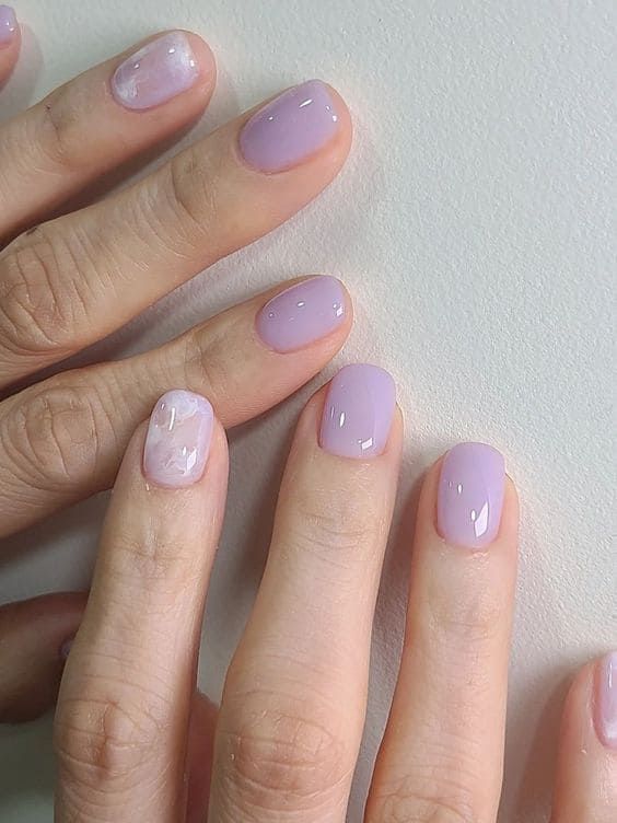 Elegant Lavender Nail Design with Marbled Accent for a Calming Finish.