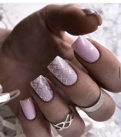 Elegant Soft Pink Nail Design with Intricate Patterns and Sophisticated Finishes