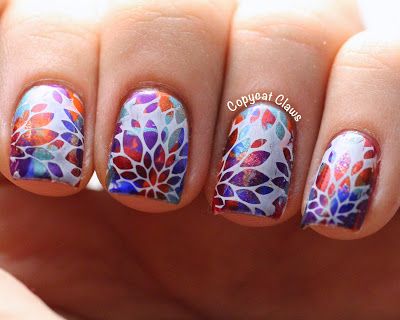 Vibrant Floral Nail Design with Intricate Multicolored Patterns.