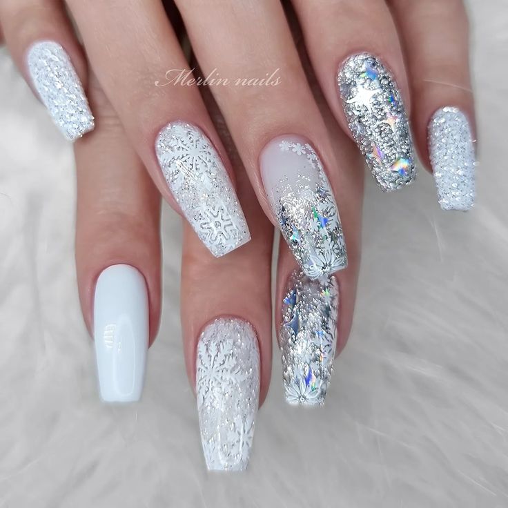 Chic Winter Nail Design: Delicate Snowflakes and Shimmering Accents for a Frosty Glamour.