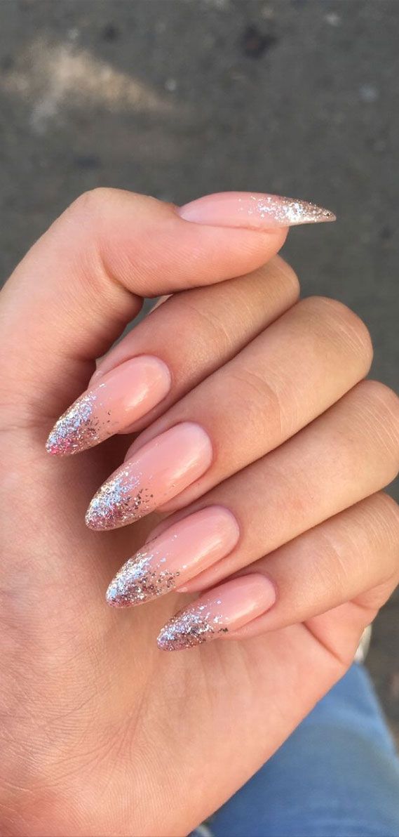 Elegant Glittery Ombre Nails: A Sophisticated Blend of Classic Nude and Sparkling Tips.