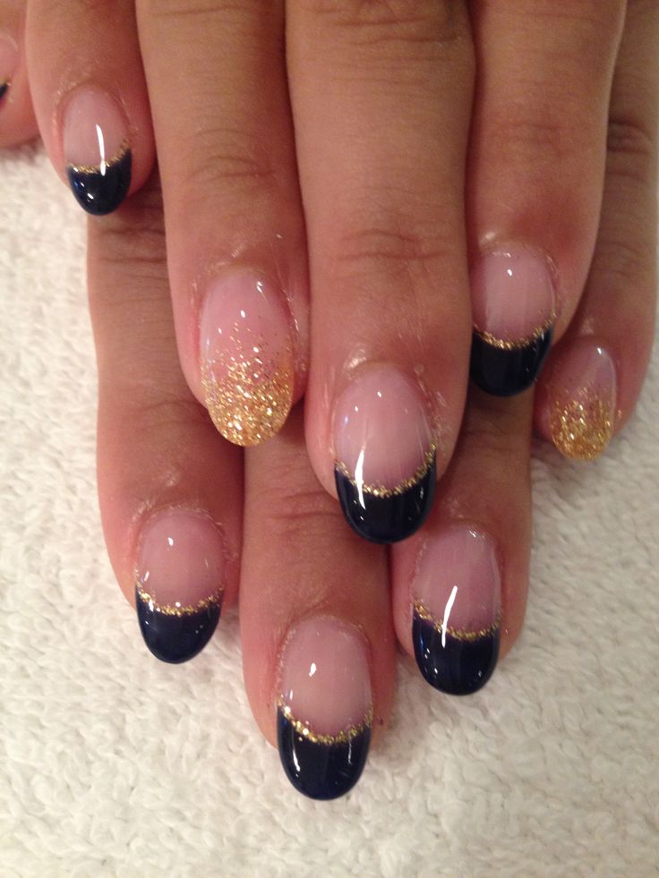 Chic Navy Blue French Tip Nails with Gold Glitter on a Nude Base for Effortless Elegance.