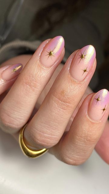 Chic Ombre Nail Design with Golden Star Accents for a Sophisticated Touch.