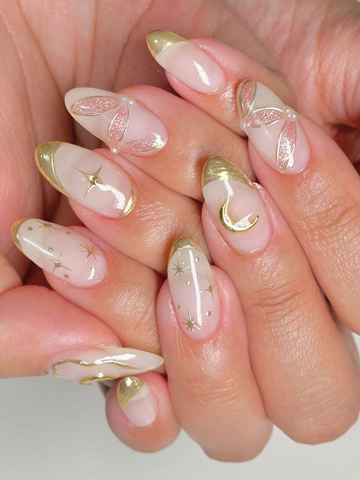 Chic Nail Design with Soft Nude and Gold Accents Showcasing Celestial Intricacies.