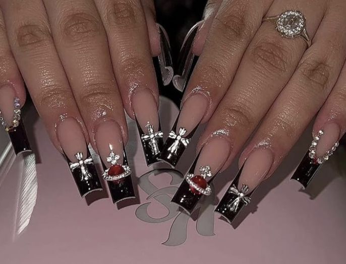 Elegant Long Nail Design with Intricate Embellishments and Sophisticated Black and Nude Contrasts.