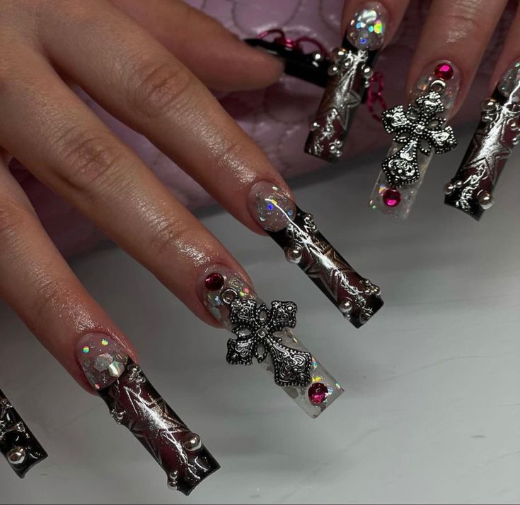 Gothic Elegance: Bold Black and Silver Nail Design with Metallic Embellishments and Glamorous Accents.