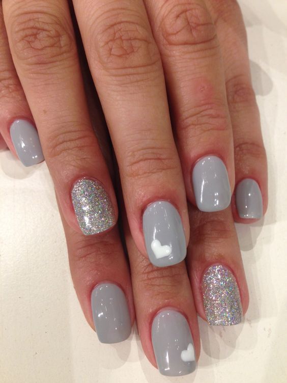 Chic Gray Nail Design with Shimmering Accent and Playful Heart Accents