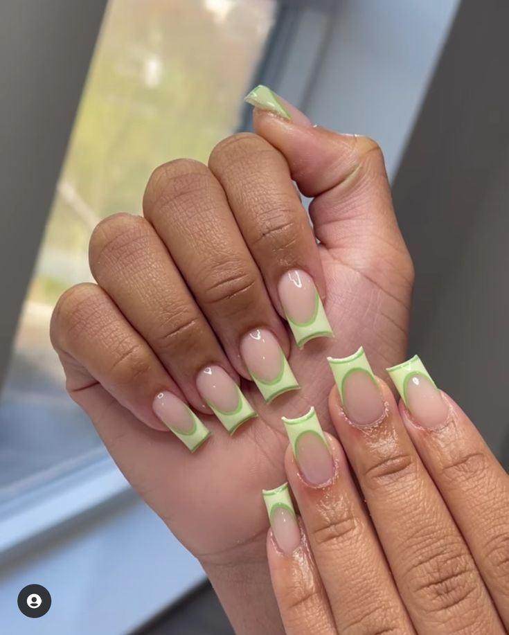 Trendy Mint Green-Tipped French Manicure with Playful Geometric Shapes.