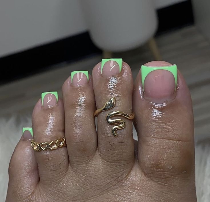 Chic Green Geometric Nail Design with Elegant French Tips and Gold Accents