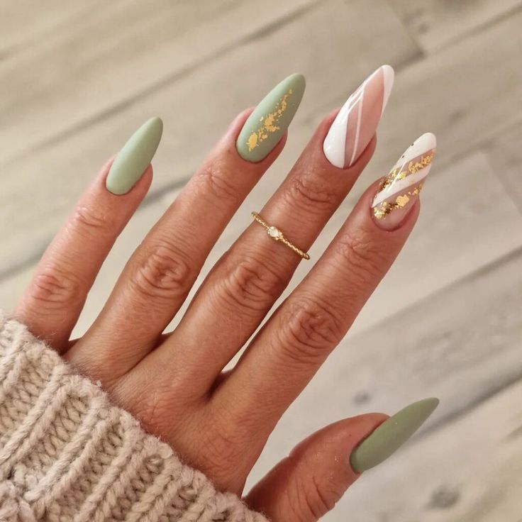 Sophisticated Green Matte Almond Nails with Glossy White Accent and Gold Foil Accents.