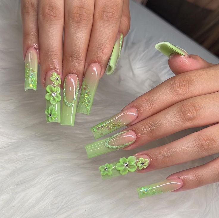 Playful Vibrant Green Stiletto Nail Design with Floral and Glitter Accents.