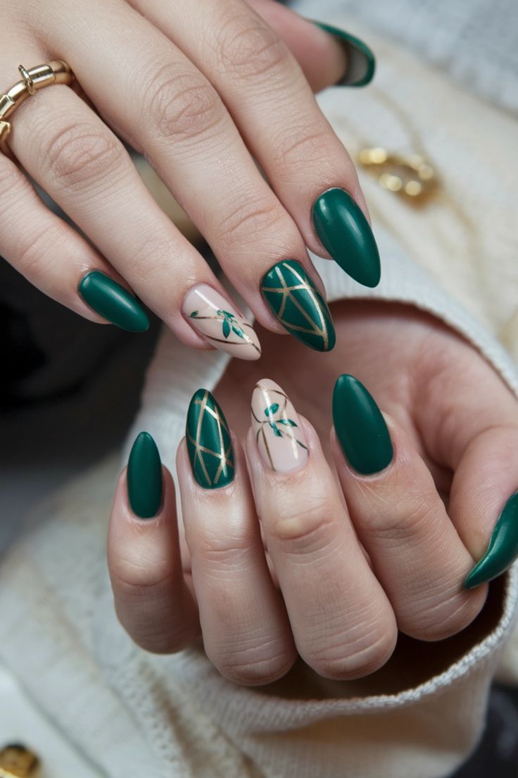 Sophisticated Emerald and Nude Nail Design with Gold Geometric Accents.