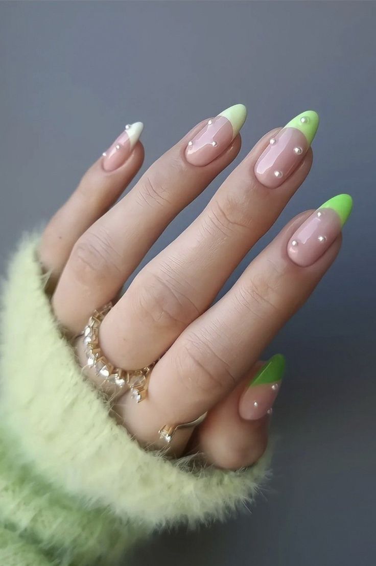 Playful and Stylish Soft Pink Manicure with Neon Green Tips and Pearl Accents.