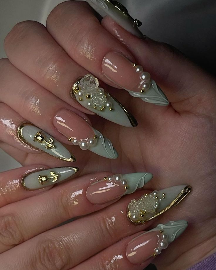 Sophisticated Nail Art: Soft Green and Nude Elegance with Textured Floral Embellishments and Gold Accents.