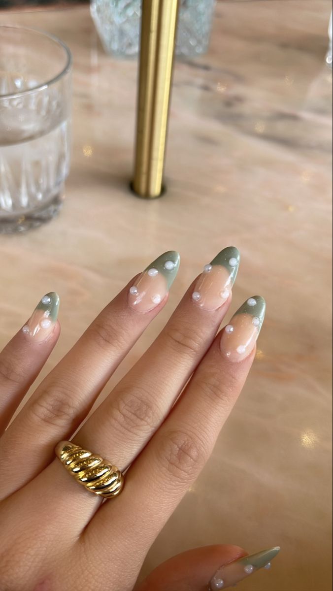 Sophisticated Elegance: Nail Design in Soft Nude and Muted Green with Pearl Accents.