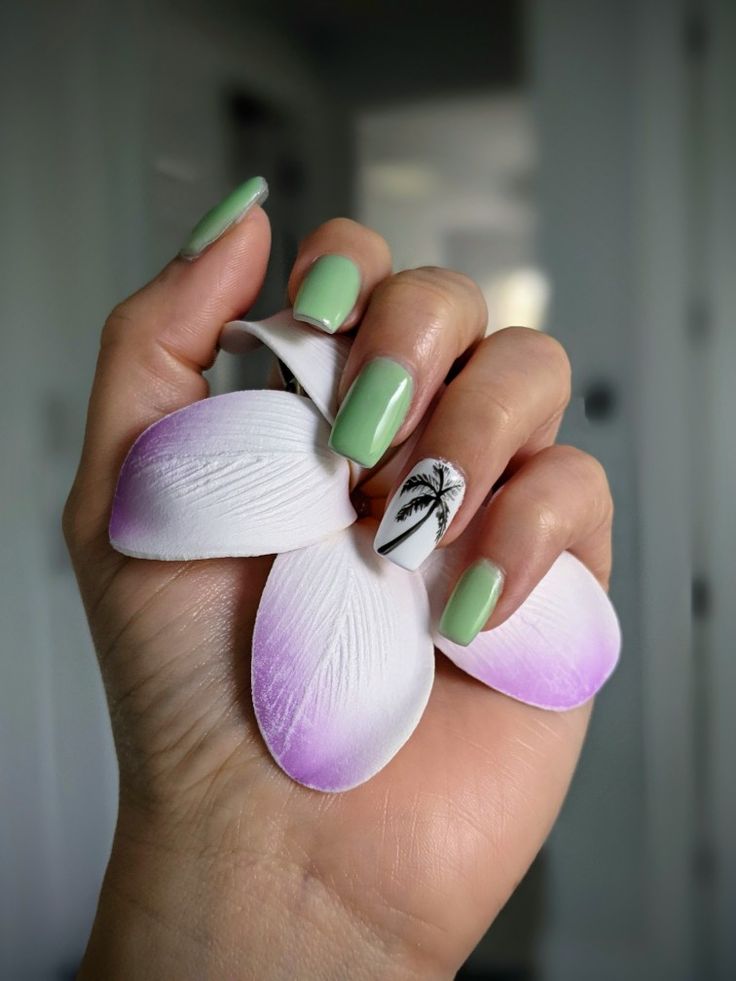 Chic Tropical Mint Green Nail Design with Palm Tree Accent and Floral Petals