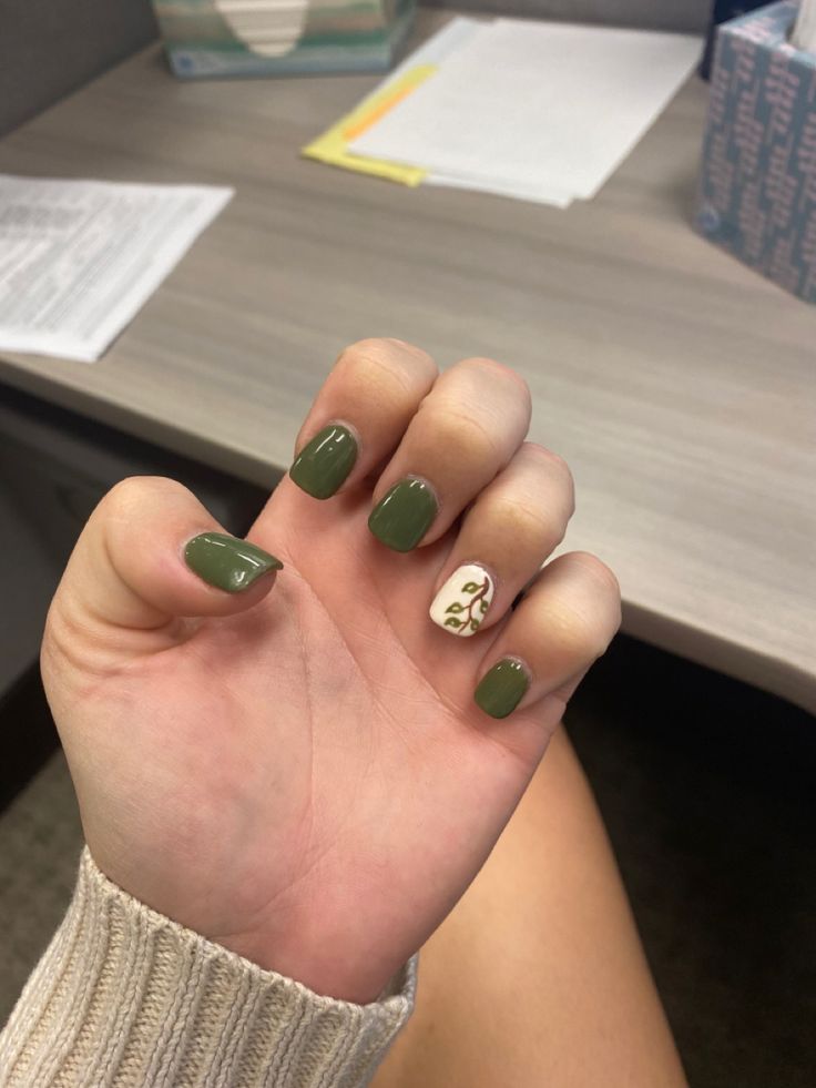 Chic Deep Green Nail Design with Earthy Accent Vine Pattern.