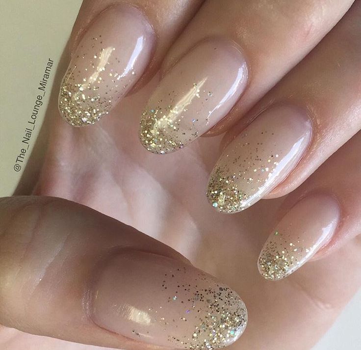 Elegant Ombre Nude Nails with Shimmering Gold Glitter for a Sophisticated Glam Look.