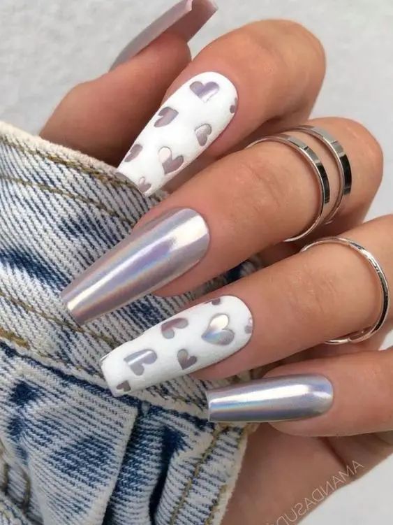 Elegant Nail Design: Glossy Silver and Heart Motifs for a Chic, Romantic Look.