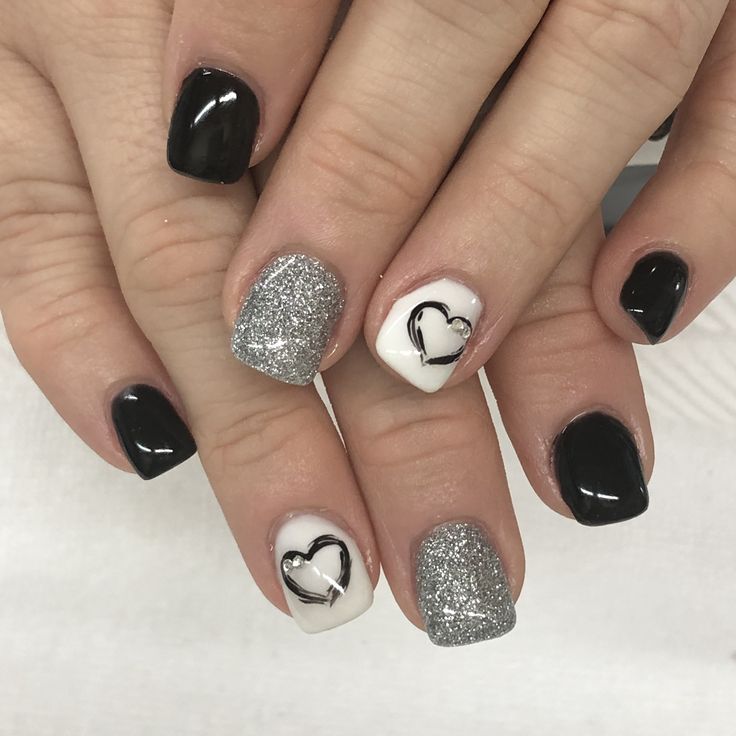 Elegant Chic Nail Design in Black, White, and Sparkling Silver.