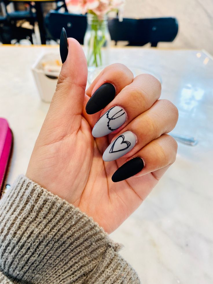 Elegant Matte Black and Light Gray Nail Design with Heart and Chain Accents