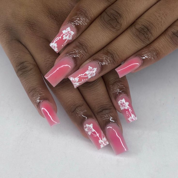 Charming Pink Ombre Nails with Delicate Floral Designs for a Feminine Spring Aesthetic.