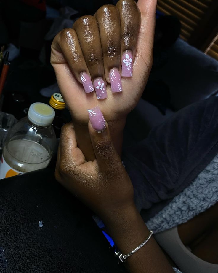 Sophisticated Soft Pink Nail Design with Elegant White Floral Accents.