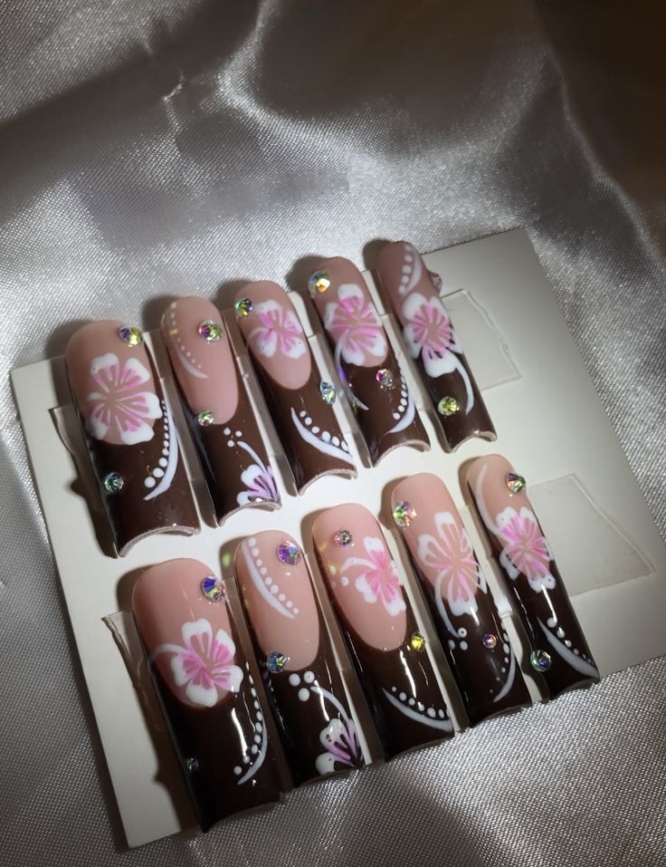 Charming Sophisticated Nail Design with Brown, Nude, Floral Patterns, and Rhinestones