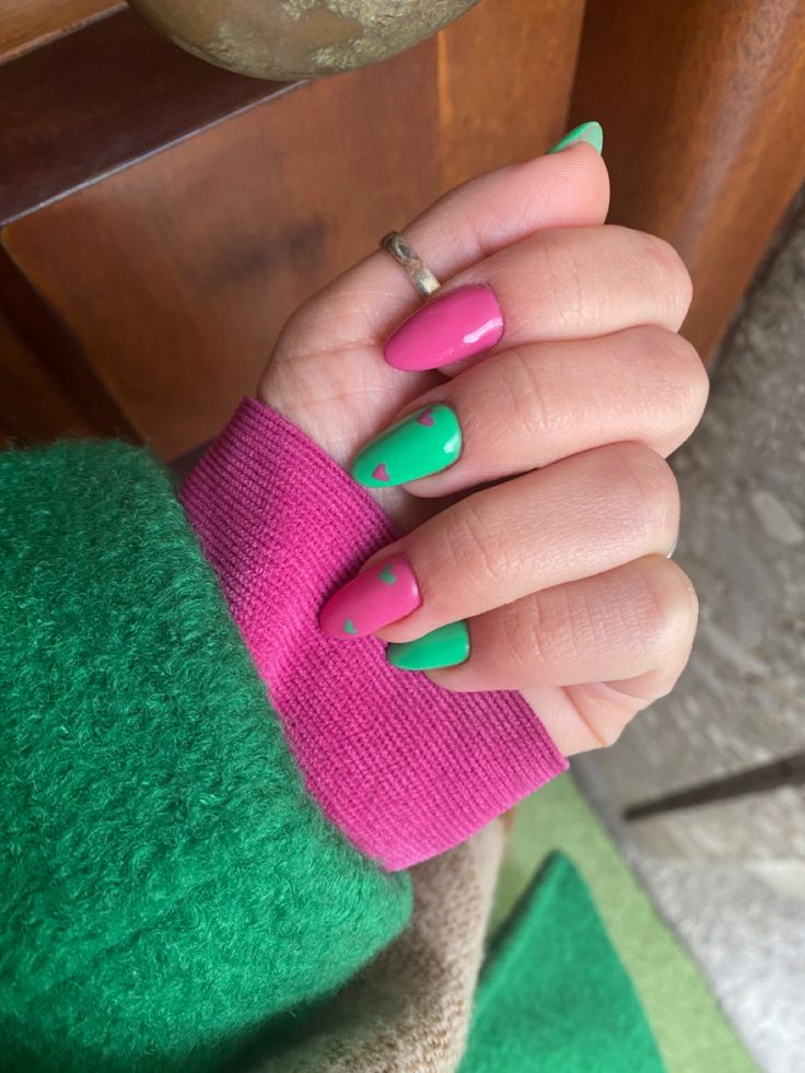 Vibrant Nail Design with Bright Pink and Green Shades Featuring Whimsical Heart Motifs.