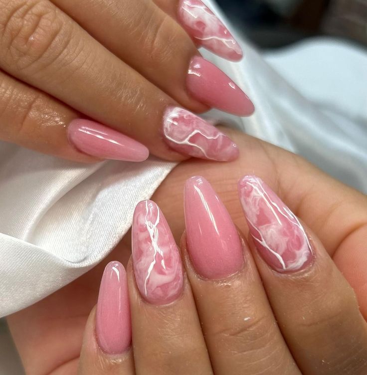 Sophisticated Almond-Shaped Pink Marble Nail Design with Subtle White Swirls.