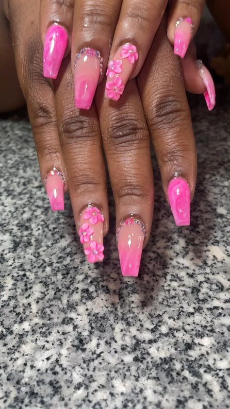 Playful Pink Nail Design with Glossy Finishes and Floral Rhinestone Accents.