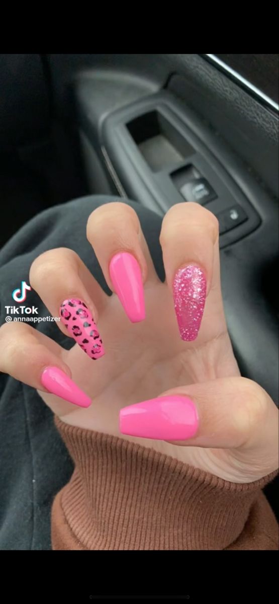 Bold Vibrant Pink Nails with Playful Leopard Print and Sparkly Glitter Accents.