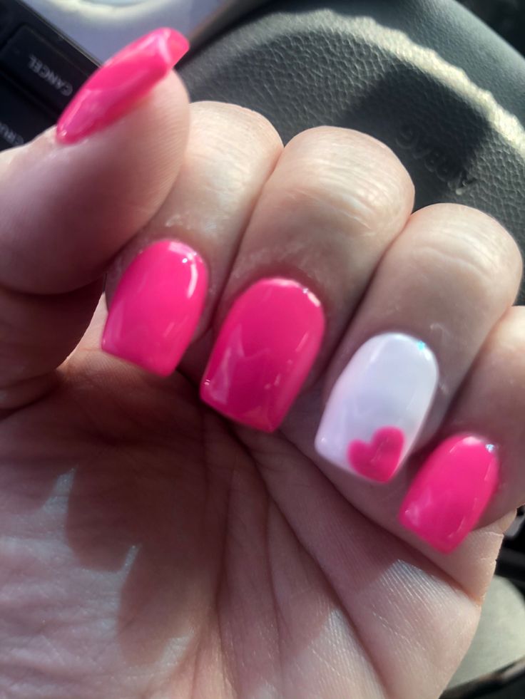 Playful Vibrant Pink Nail Design with Heart Accent for a Chic Touch.